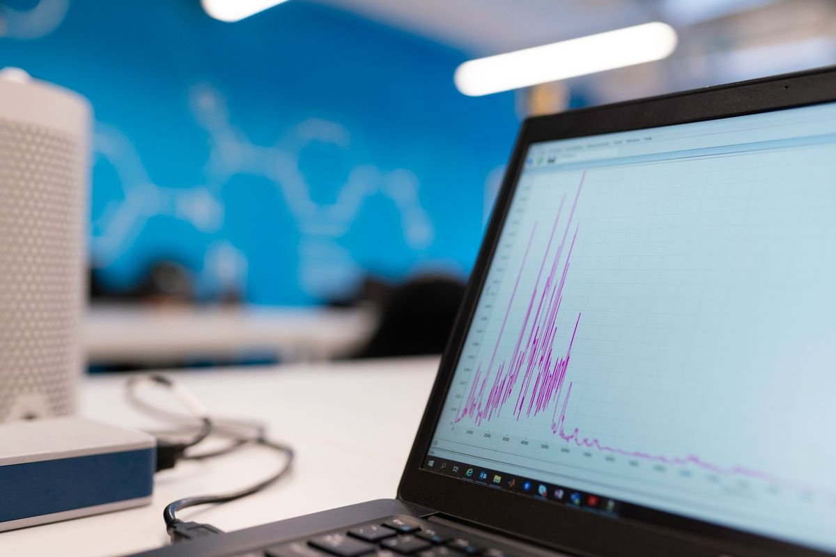 Marketer reviewing a graph on a laptop screen, representing schema markup and search visibility tracking for a home care website